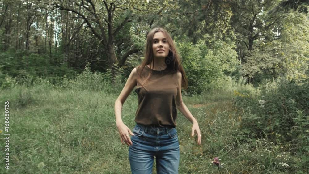 Sexy tourist walking in park after lessons, student portrait, Dynamic pretty woman in a forest in slow motion Sexy tourist walking in park after lessons, student portrait, Dynamic pretty woman in a forest in slow motion
