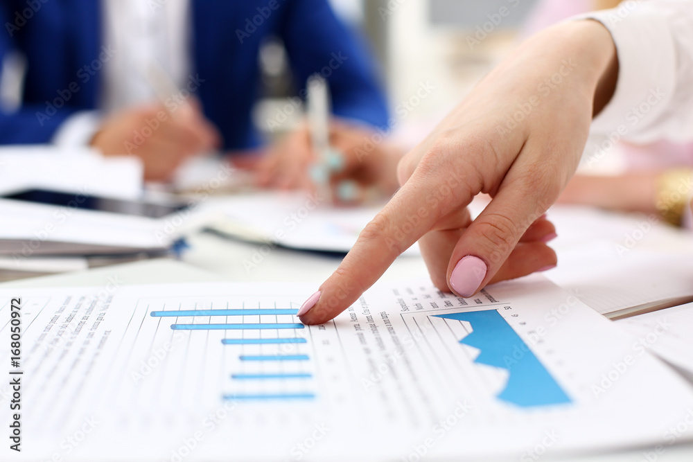 Female arm point pinger in financial graph Female arm point pinger in financial graph