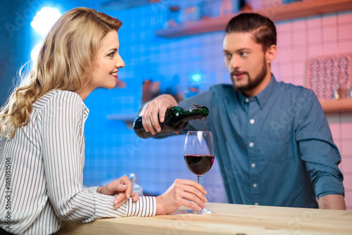 bartender pouring wine to woman