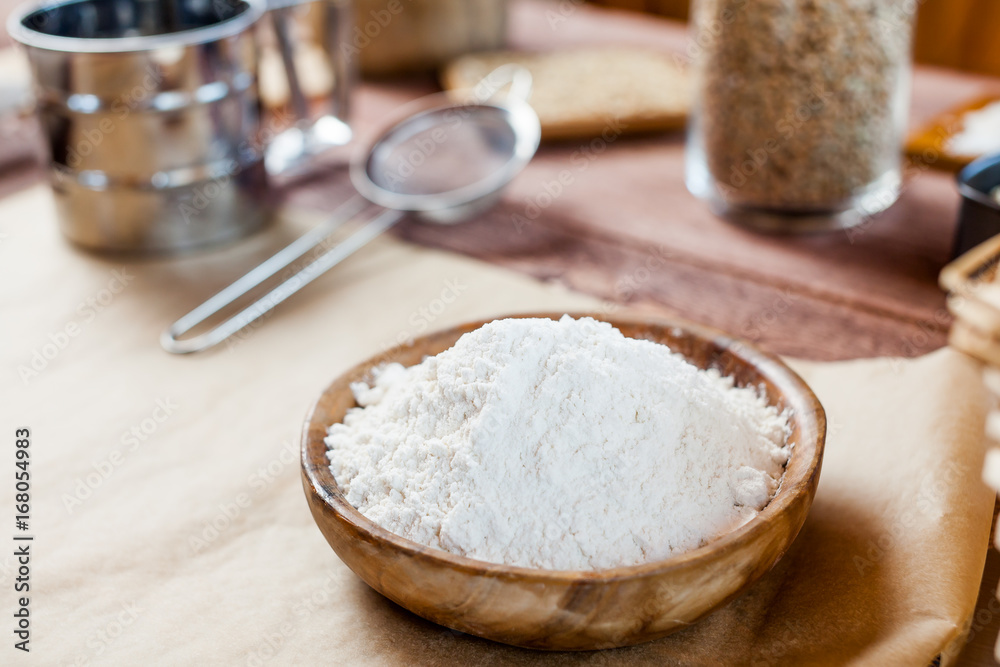 wheat and flour on rustic wooden table wheat and flour on rustic wooden table