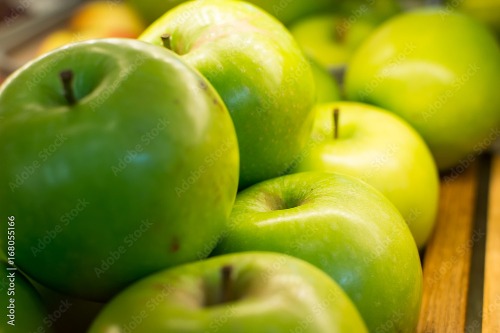 Group of ripe green apples on wooden tray Group of ripe green apples on wooden tray