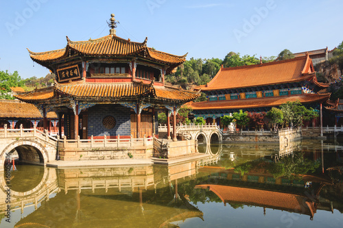 Traditional Chinese architecture with reflections in a pond in Confucius Buddhist temple © okonato