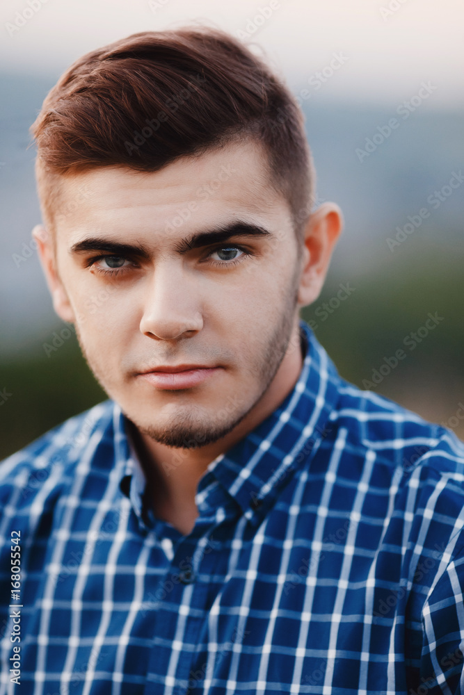 Fototapeta premium Portrait of a man close-up hipster with beard, sideburns, beard and styling, dark hair.