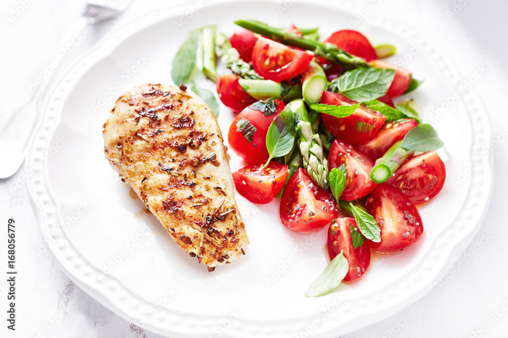 Grilled chicken breast with asparagus and cherry tomato salad