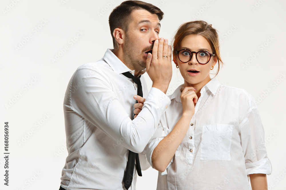 The business man and woman communicating on a gray background The business man and woman communicating on a gray background
