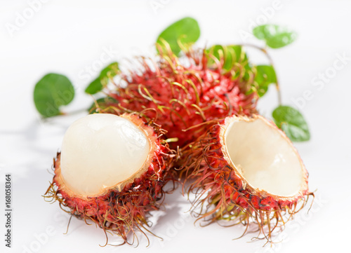 Cluster of peeled rambutan fruits with vanilla isolated on white background