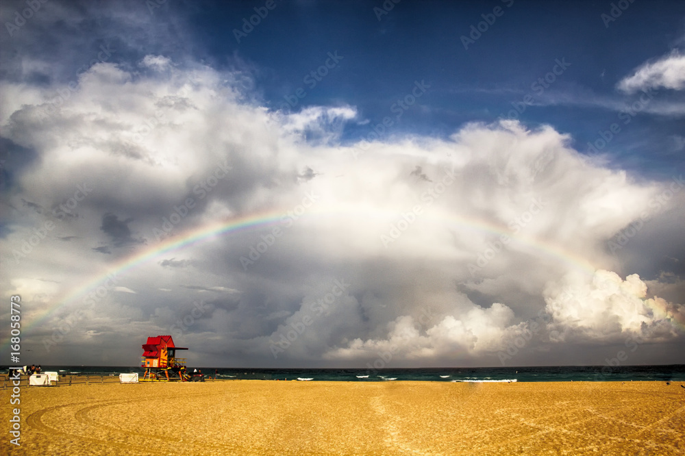 Miami Beach lifeguard tower after storm with rainbow.