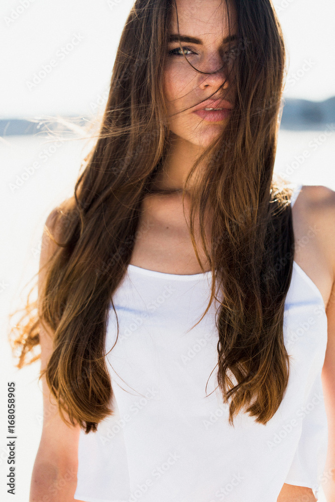 Portrait of brunette woman with long shiny hair