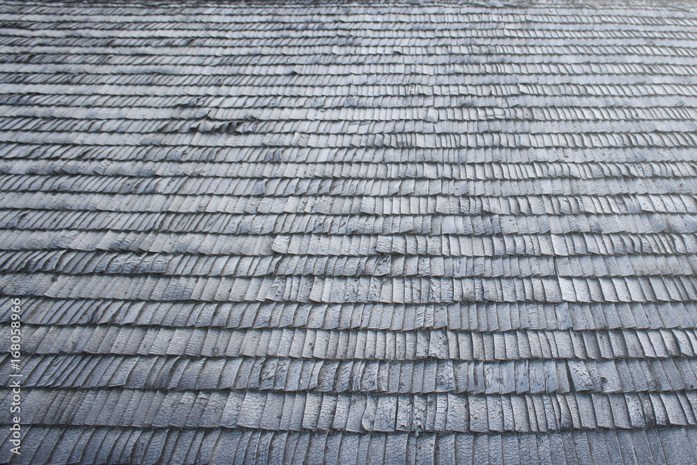 Old wood tiles on house roof.
