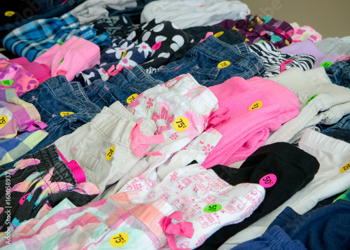 Colorful clothing with price tags at garage sale