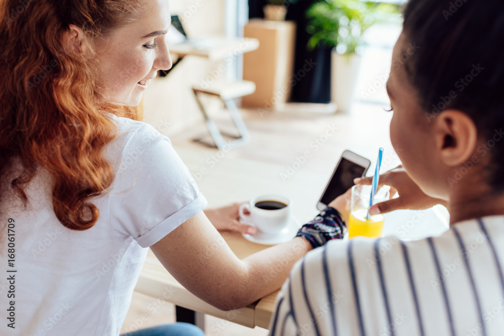 multiethnic girls using smartphone multiethnic girls using smartphone