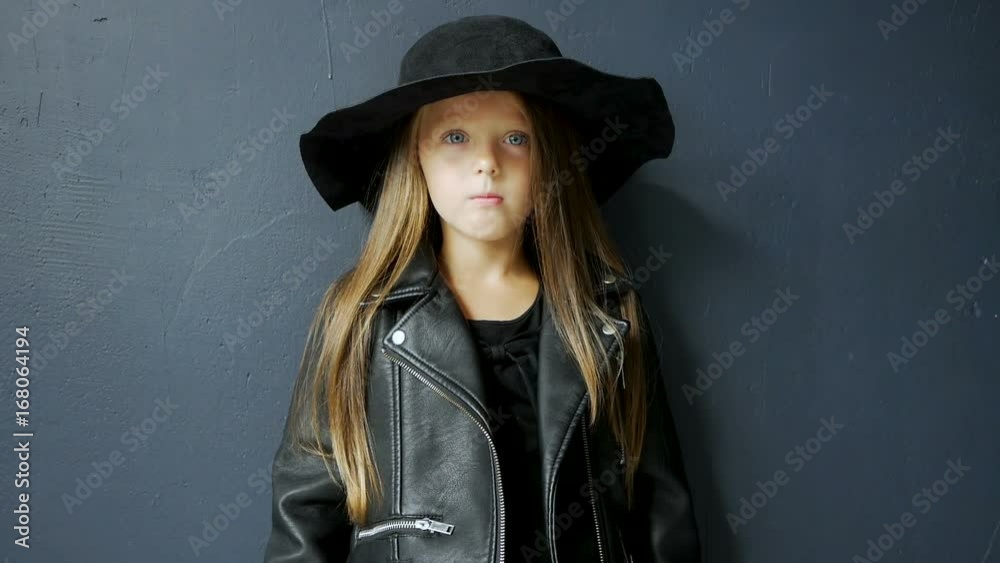 girl in rocker style is in the studio next to the stairs girl in rocker style is in the studio next to the stairs