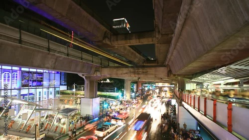 crowd of people walking with traffic jam at Siam center,  Bangkok Thailand