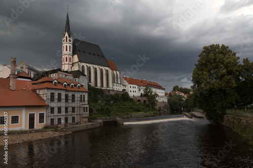 Heavy clouds over the red roofs af chehien town Cheski-Krumlov