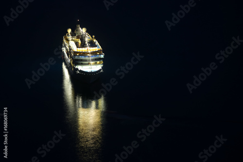 An illuminated cruise ship in the Adriatiac sea at night in Dubrovnik, Croatia.
