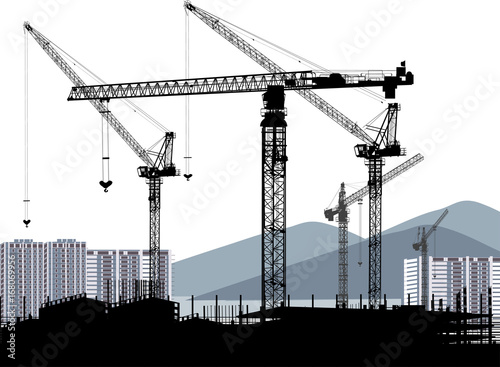 industrial cranes and house building near mountains