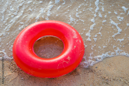 Fototapeta Naklejka Na Ścianę i Meble -  red inner tube on the beach
