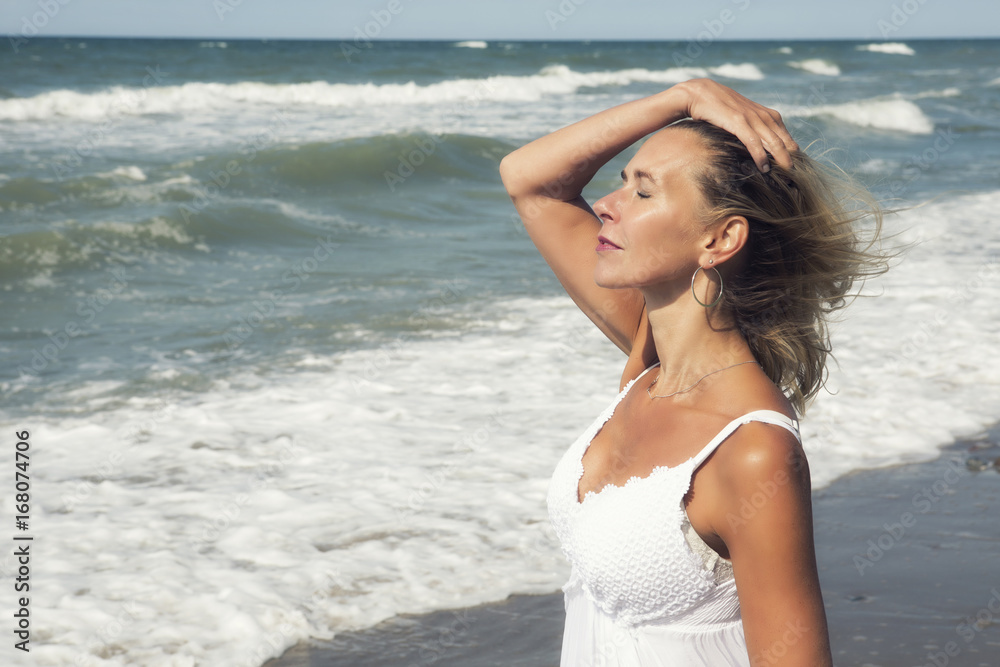 blond woman enjoying the sun and beach