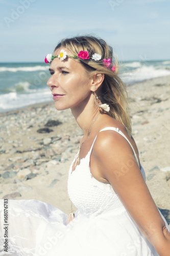 beautiful blond woman sitting on the beach