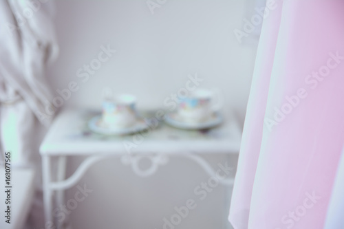 Background tulle and in blur two cups photo