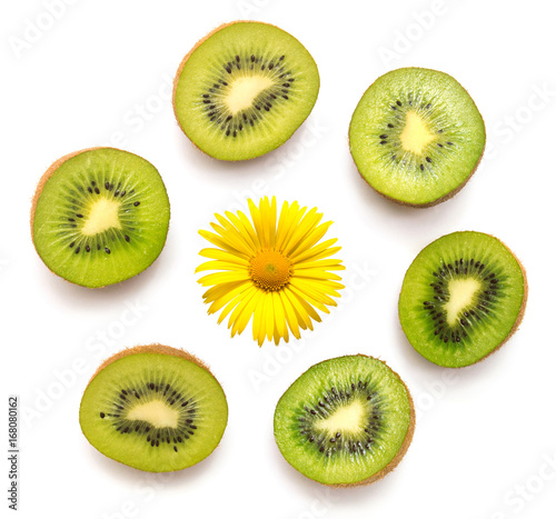 Kiwi fruit with a flower of camomile isolated on white background. Kiwi collection. Top view, flat