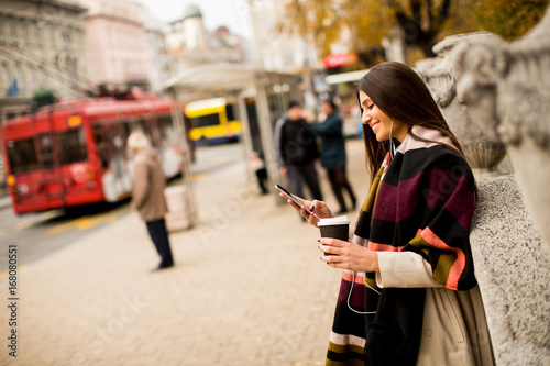 Pretty young woman on the street at autumn day