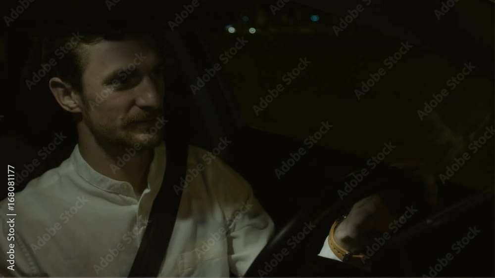 Young Businessman Smiling While Driving a Car
