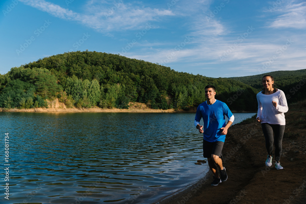Fototapeta premium Going for a jog by the lake together