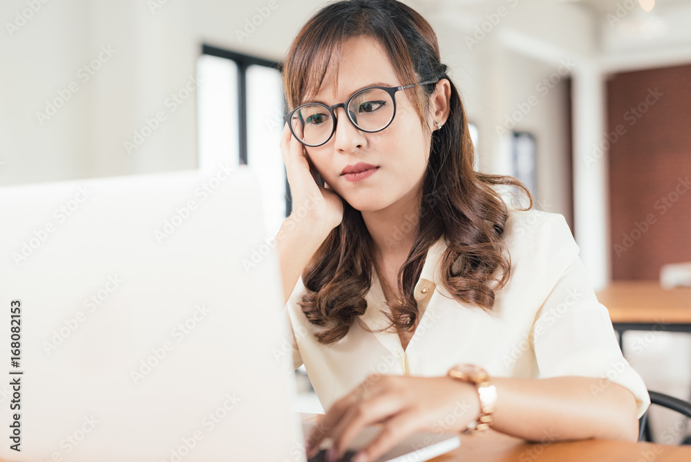 Asian young business freelance woman concentrate working online business with laptop and cell phone in cafe shop. Working, Success, concentrate concept. Asian young business freelance woman concentrate working online business with laptop and cell phone in cafe shop. Working, Success, concentrate concept.
