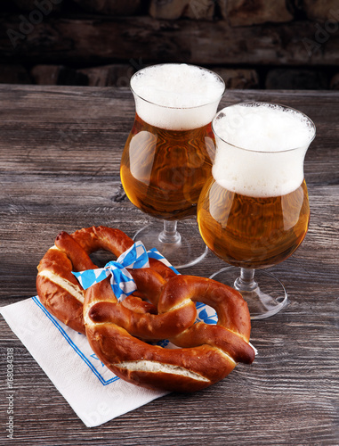 Original bavarian pretzels with beer on wooden board. Oktoberfes photo