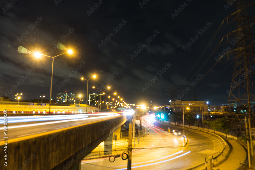 motion blurred and light trail of car on and under the rama 7 bridge with dark sky and cloud