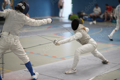 Girls fencing Foil at a tournament