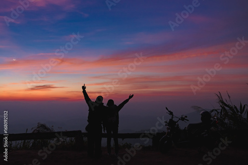 silhouette lover let go travel on the road with motorcycle, nice motorcycle with lover happy