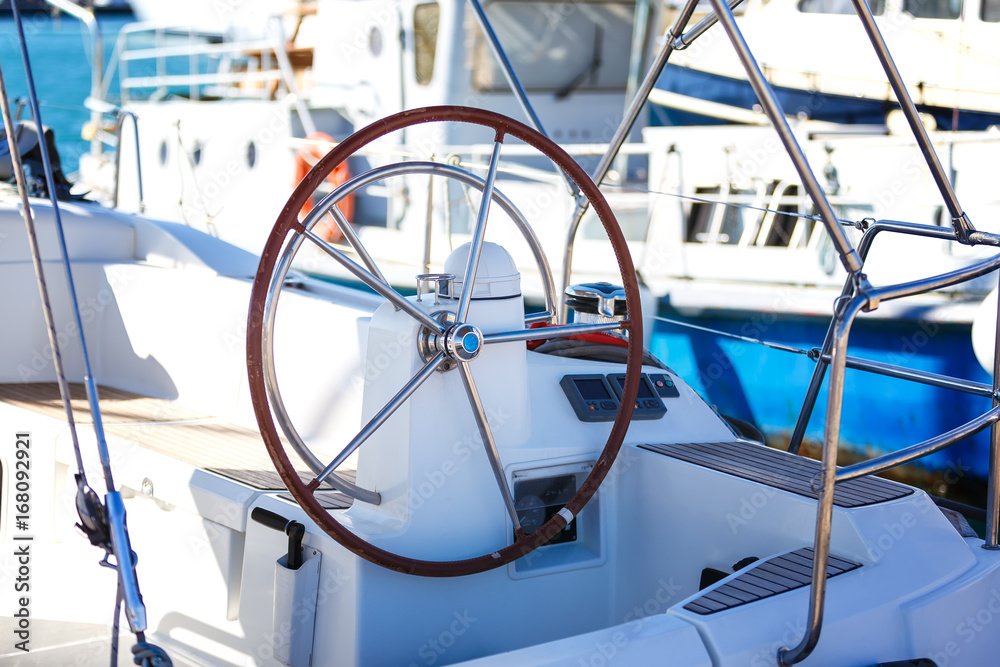 detail of steering wheel and navigation instruments of a sailboat. blur depth of field