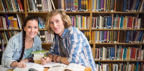 Composite image of college students doing homework in library photo