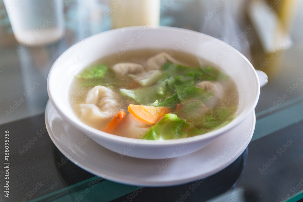 Hot wanton soup with vegetable and steam. Served in the restaurant at Gangtok. Sikkim, India. Hot wanton soup with vegetable and steam. Served in the restaurant at Gangtok. Sikkim, India.
