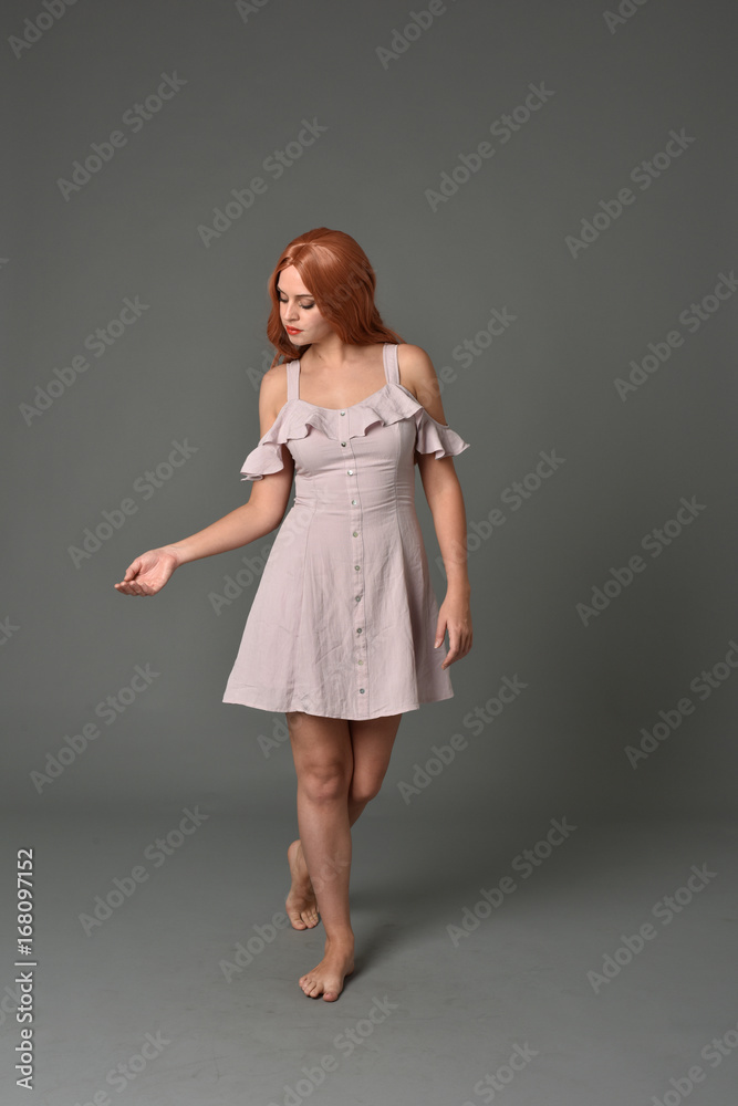 full length portrait of pr a pretty girl wearing simple purple dress, standing pose against a grey background full length portrait of pr a pretty girl wearing simple purple dress, standing pose against a grey background