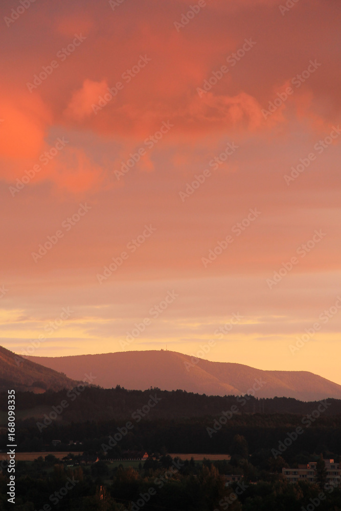 landscape of Beskydy mountains in the evening light with colorful sky and clouds