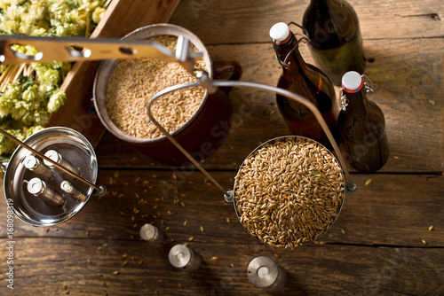 Man Weighs Malt for Home Brewing of Beer. Top View. photo