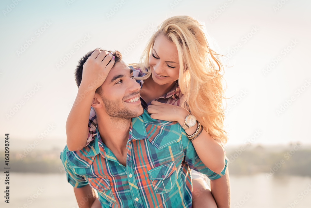 Smiling romantic couple in love having fun at the beach Smiling romantic couple in love having fun at the beach