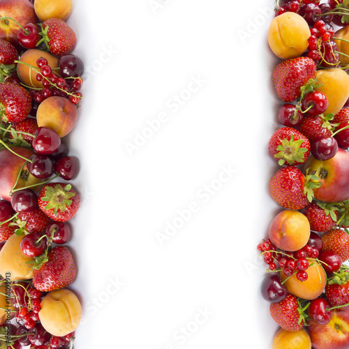 Ripe strawberries  redcurrants  apricots  nectarines and cherries on white background. Various fresh summer berries. Top view. 