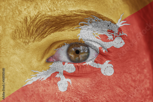 Human face and eye painted with flag of Bhutan photo