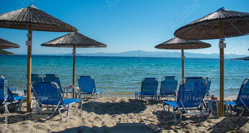 Sun chairs on the beach with sea in background. Summer holiday   vacation. Xenia Golden Beach  Paliouri  Chalkidiki  Greece on a beautiful summer day