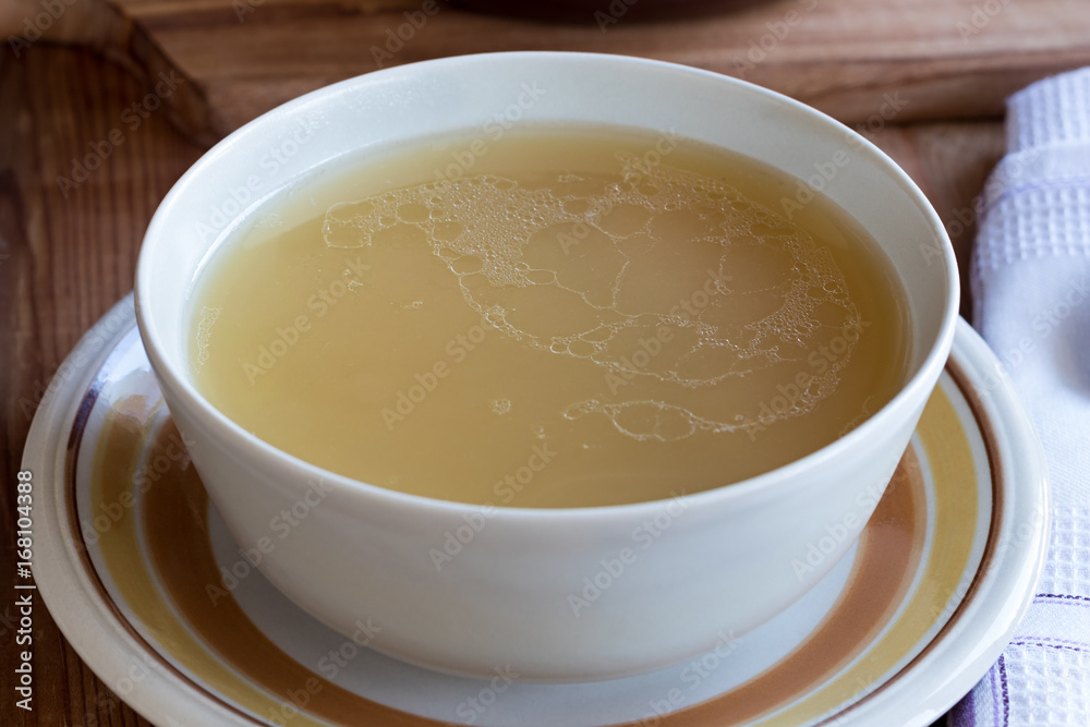 Chicken bone broth served in a soup bowl Chicken bone broth served in a soup bowl