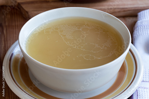 Chicken bone broth served in a soup bowl