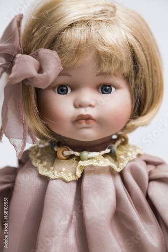 Ceramic porcelain handmade doll with blond hair and pink dress