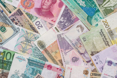 many different currency banknotes from world country as background photo