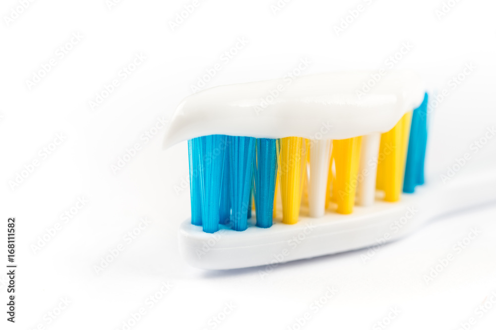 Closeup macro toothpaste on toothbrush isolated over white background Closeup macro toothpaste on toothbrush isolated over white background