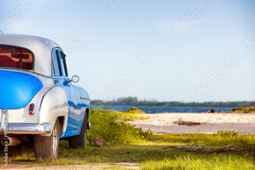 Beautiful american vintage car parked at the beach. Plaia Larga, Cuba photo