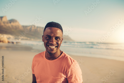 Afro american man smiling at the beach